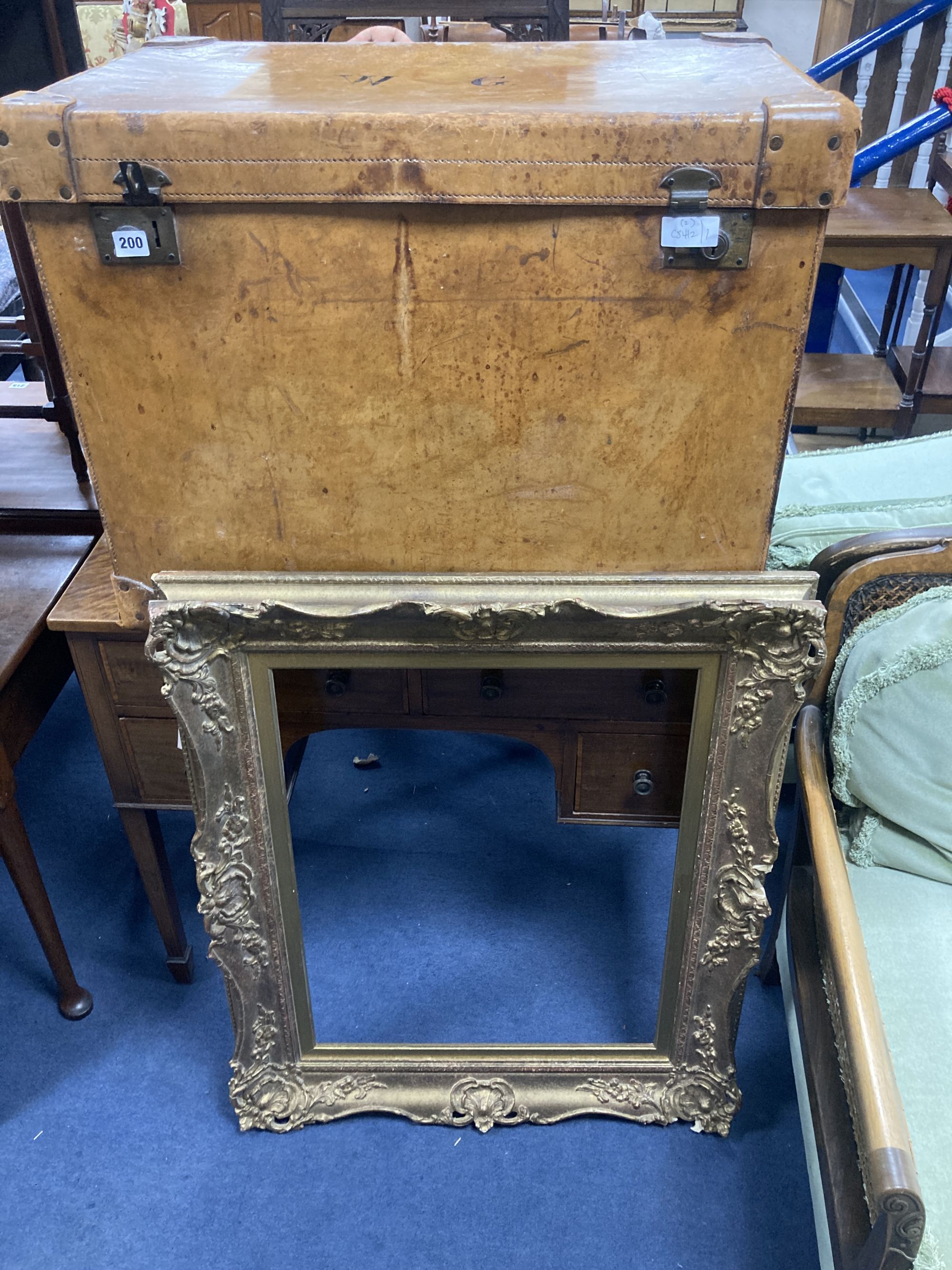 A large Victorian tan leather travelling trunk, width 76cm, depth 52cm, height 58cm together with a rectangular gilt gesso picture fram